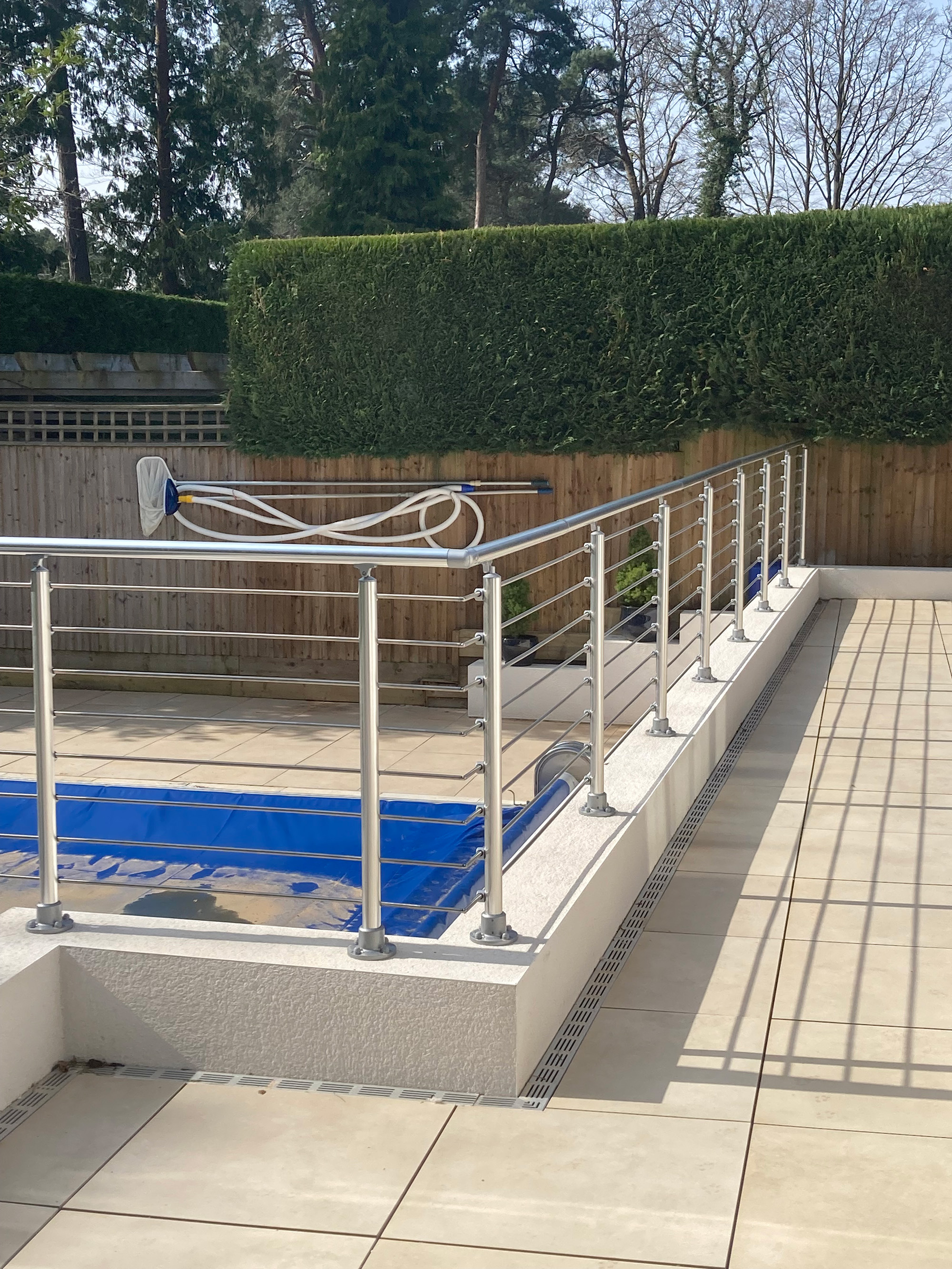 Balustrade system in pool area with floor mounted posts